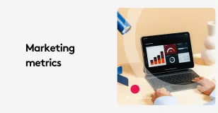 Person viewing marketing metrics dashboard on a laptop with analytics graphs.