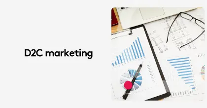 D2C marketing analysis with charts and documents on a desk.