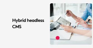 People discussing hybrid headless CMS using a tablet in an office setting.