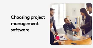 Group of professionals discussing project management software in an office.