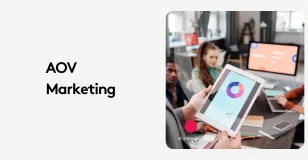 Tablet showing analytics in marketing meeting with team discussion.