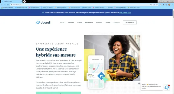 Smiling woman in plaid shirt holding a smartphone with Uberall CoreX hybrid experience text.