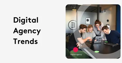 Team of four collaborating on laptops at a digital agency meeting.