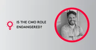 Portrait of a smiling man in a striped shirt with text 'Is the CMO role endangered?' on a gray background.