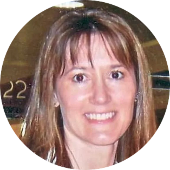 Smiling woman with brown hair in casual attire.