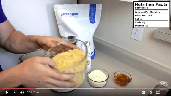 Person measuring ingredients with MyProtein bag and nutrition facts visible.