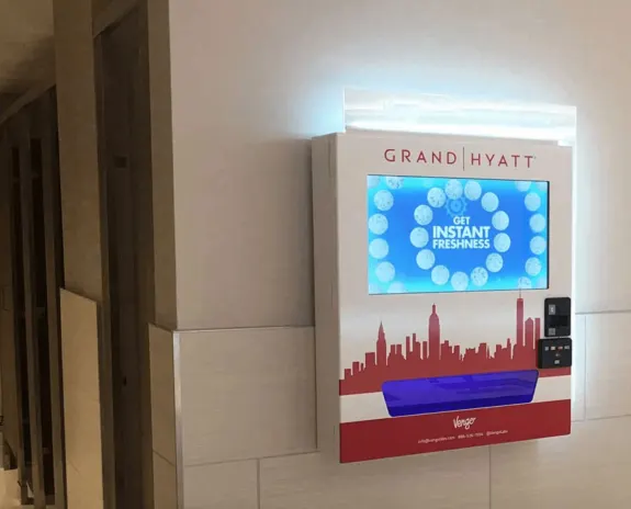 Grand Hyatt vending machine offering instant freshness in a restroom area.