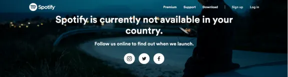 Spotify not available in your country message with night scene background