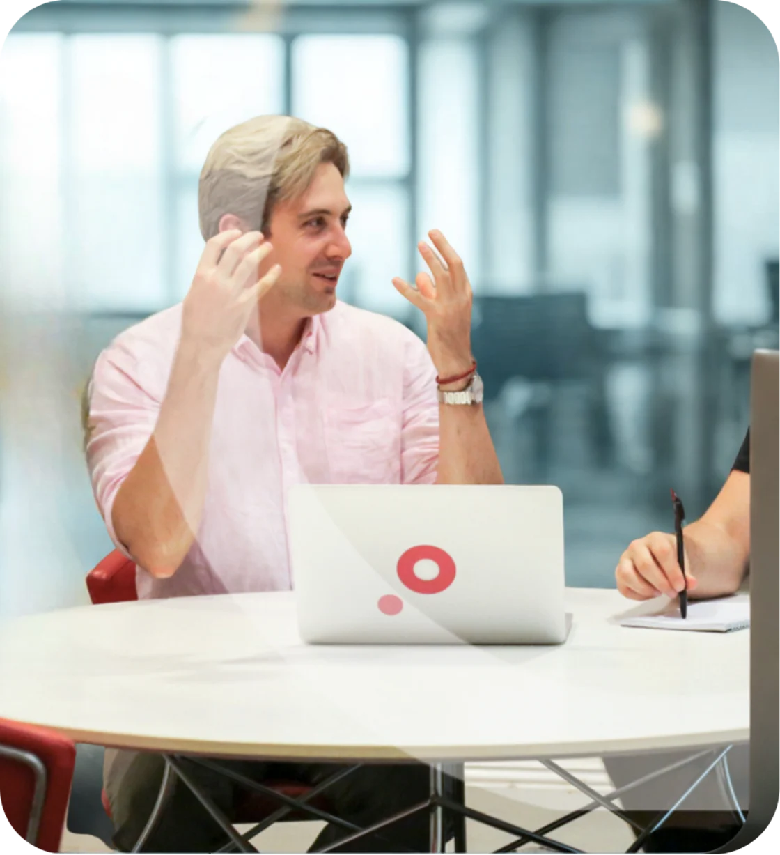An agency team works together at a laptop.
