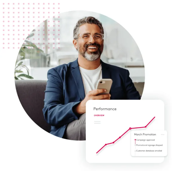 Smiling businessman holding phone with performance chart overlay.