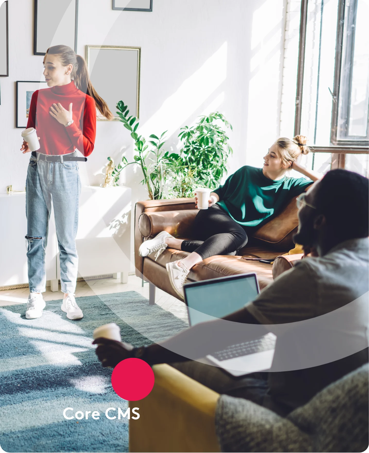 Colleagues having a casual meeting in a bright office with coffee and laptops.