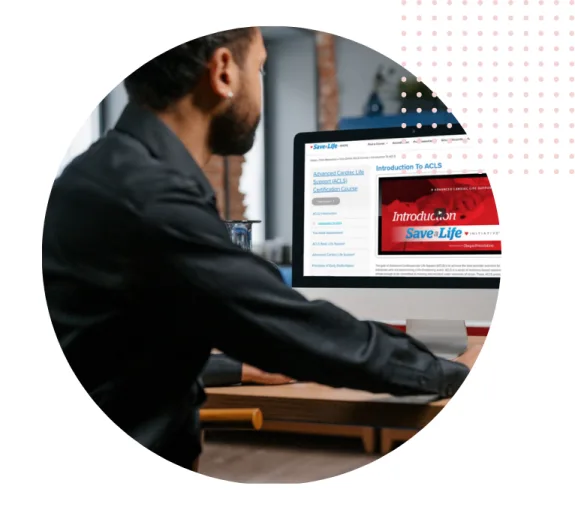 Man viewing online ACLS course on computer at desk.