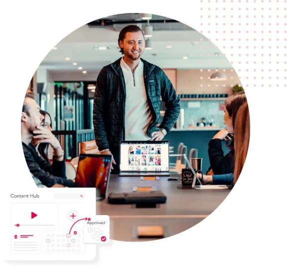 Team meeting in office with a laptop displaying images on the table