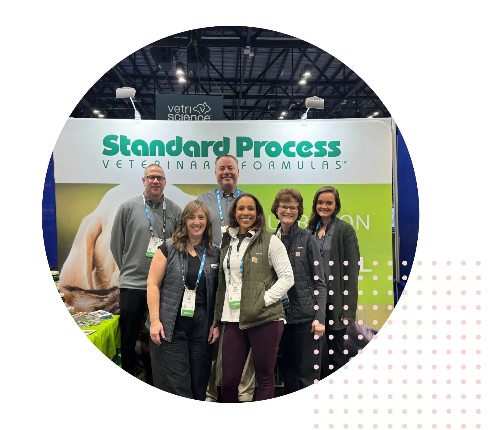 Group of people at Standard Process booth during a veterinary exhibit.