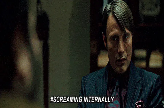 Man sitting with text screaming internally as a reaction gif.